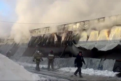 In this Russian Emergency Situations Ministry photo, made available on Thursday, Jan. 4, 2018, Firefighters attend the scene of a fire at a shoe-manufacturing company in the village of Chernoretsky, about 2800 kilometers (1800 miles) east of Moscow, Russia. Russian news reports say at least 10 people have been killed in a warehouse fire in a Siberian village and that the dead are believed to be workers from China and Kyrgyzstan.