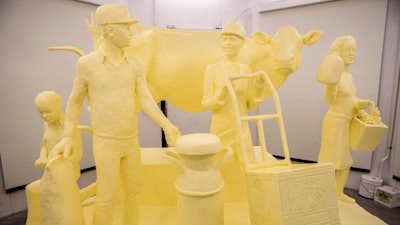 This Wednesday, Jan. 3, 2018, photo provided by the Pennsylvania Department of Agriculture shows a sculpture carved from a half-ton of butter in preparation for the 102nd Pennsylvania Farm Show, scheduled from Saturday, Jan. 6, through Saturday, Jan. 13, at the Pennsylvania Farm Show Complex and Expo Center in Harrisburg, Pa. The sculpture unveiled Thursday, Jan. 4, 2018, sponsored by the American Dairy Association North East (ADANE), reflects the show's theme this year, 'Strength in our Diversity,' by depicting a dairy cow; a dairy farmer, second from left; an agronomist who helps produce corn to feed dairy cows, left; a milk processor, second from right; and a consumer, right, carrying agriculture products from Pennsylvania.
