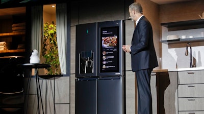 LG's David Vander Waal introduces the InstaView ThinQ smart refrigerator during a news conference at CES International, Monday, Jan. 8, 2018, in Las Vegas.