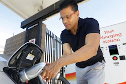 In this Thursday, Sept. 17, 2015 file photo, Darshan Brahmbhatt, plugs a charger into his electric vehicle at the Sacramento Municipal Utility District charging station in Sacramento, Calif. Calif., Gov Jerry Brown, on Friday, Jan. 26, 2018, issued and executive order outlining a plan to put 5 million zero-emission vehicles on California's roads by 2030.