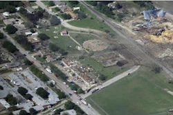 This April 18, 2013 aerial file photo shows the remains of a nursing home, left, apartment complex, center, and fertilizer plant, right, destroyed by an explosion at a fertilizer plant in West, Texas. Federal authorities announced Wednesday, May 11, 2016, that the fire that caused the deadly explosion in 2013 was a criminal act. The explosion killed 15 people, injured hundreds and left part of the small town in ruins.