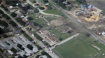 This April 18, 2013 aerial file photo shows the remains of a nursing home, left, apartment complex, center, and fertilizer plant, right, destroyed by an explosion at a fertilizer plant in West, Texas. Federal authorities announced Wednesday, May 11, 2016, that the fire that caused the deadly explosion in 2013 was a criminal act. The explosion killed 15 people, injured hundreds and left part of the small town in ruins.