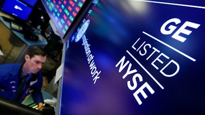 Specialist John McNierney works at the post that handles General Electric on the floor of the New York Stock Exchange, Tuesday, Jan. 16, 2018. GE CEO John Flannery, who was put in charge of reviving the company last summer, revealed significant issues at GE Capital on Tuesday, which will lead to a $6.2 billion after-tax charge in the fourth quarter.