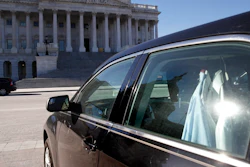 Extra shirts hang inside of a senator's vehicle as the Capitol dome is reflected on Capitol Hill as a bitterly-divided Congress hurtles toward a government shutdown this weekend, Friday, Jan. 19, 2018, in Washington.
