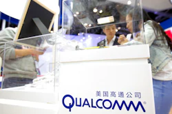In this Thursday, April 27, 2017 file photo, visitors look at a display booth for Qualcomm at the Global Mobile Internet Conference (GMIC) in Beijing. The European Union is slapping a $1.23 billion fine on U.S. chipmaker Qualcomm for abusing its market dominance in the lucrative sector of vital components in smartphones and tablets.