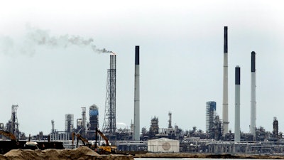 In this Sept. 30, 2011, file photo, part of the Royal Dutch Shell refinery is seen on Pulau Bukom, five kilometers (3 miles) off Singapore. Singapore police said Tuesday, Jan. 9, 2018, they have arrested 17 men suspected of involvement in stealing oil from Shell's largest refinery in the world. Police also seized $2.3 million and an oil tanker in connection with the case.