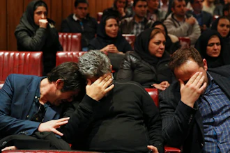 Friends and colleagues of the deceased Iranian seafarers aboard a tanker that sank off the coast of China weep at the headquarters of National Iranian Tanker Company, in Tehran, Iran, Sunday, Jan. 14, 2018. The burning Iranian tanker listing for days off the coast of China after a collision with another vessel sank Sunday, with an Iranian official saying there was 'no hope' of survival for the 29 missing sailors onboard.