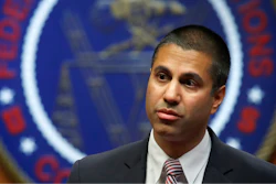 In this Dec. 14, 2017, file photo, Federal Communications Commission Chairman Ajit Pai arrives for an FCC meeting on net neutrality, in Washington. A group of 22 state attorneys general has sued to block the Federal Communications Commission’s repeal of net-neutrality rules. These rules barred companies like AT&T, Comcast and Verizon from interfering with internet traffic and favoring their own sites and apps. Pai’s push to undo them inspired both street and online protests in defense of the Obama-era rules.