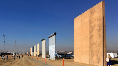 This Oct. 26, 2017 file photo shows prototypes of border walls in San Diego. A U.S. official says recent testing of prototypes of President Donald Trump’s proposed wall with Mexico found their heights should stop border crossers. U.S. tactical teams spent three weeks trying to breach and scale the models in San Diego. An official with direct knowledge of the results said they point to see-through steel barriers topped by concrete as the best design. The official spoke to The Associated Press on condition of anonymity because the information is not authorized for release.