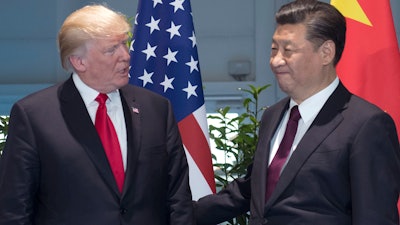 In this Saturday, July 8, 2017, file photo, U.S. President Donald Trump, left, and Chinese President Xi Jinping arrive for a meeting on the sidelines of the G-20 Summit in Hamburg, Germany.