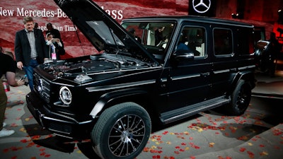 Members of the media look over the Mercedes-Benz G-Class during the North American International Auto Show, Sunday, Jan. 14, 2018, in Detroit.