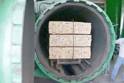 Treating wood at the current Escue Wood Treated Products facility in Milan, Tennessee.