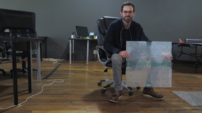 In this photo taken Dec. 5, 2017, Scanalytics co-founder and CEO Joe Scanlin holds a smart floor sensor his company creates that track people's movements in Milwaukee. The sensors are among the tools retailers are using to gain insights on consumer habits.