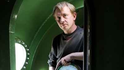 In this April 30, 2008 file photo, submarine owner Peter Madsen stands inside the vessel. A Danish prosecutor said Tuesday Jan. 16, 2018 that inventor Peter Madsen has been charged with murdering Swedish journalist Kim Wall during a trip on his private submarine, saying he either cut her throat or strangled her. Prosecutor Jakob Buch-Jepsen said Tuesday the case is 'very unusual and extremely gross.'