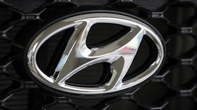 In this Oct. 26, 2017, file photo, the logo of Hyundai Motor Co. is seen on a car displayed at the automaker's showroom in Seoul, South Korea. Hyundai Motor Co. says it will release its first self-driving vehicles to markets by 2021 in partnership with U.S. self-driving technology startup Aurora Innovation Inc.