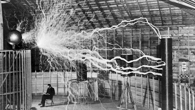 The inventor at rest, with a Tesla coil (thanks to a double exposure).