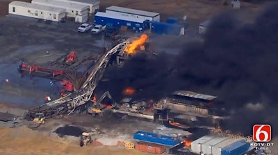 In this photo provided from a frame grab from Tulsa's KOTV/NewsOn6.com, fires burn at an eastern Oklahoma drilling rig near Quinton, Okla., Monday Jan. 22, 2018. Five people are missing after a fiery explosion ripped through a drilling rig, sending plumes of black smoke into the air and leaving a derrick crumpled on the ground, emergency officials said.