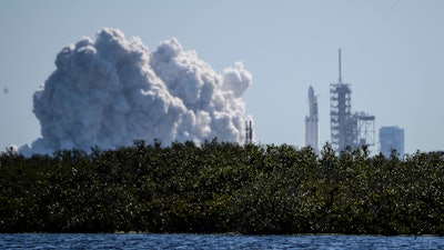 SpaceX fired up its newest, biggest rocket in a critical launch pad test Wednesday, Jan. 24, 2018, advancing toward a long-anticipated test flight possibly in just a week. The Falcon Heavy briefly roared to life for the first time at NASA's Kennedy Space Center. All three boosters — 27 engines in all — were tested.