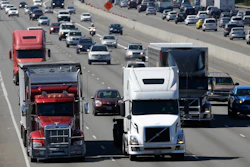In this Aug. 24, 2016, file photo, truck and automobile traffic mix on Interstate 5, headed north through Fife, Wash., near the Port of Tacoma. President Donald Trump’s plan to beef up the nation’s infrastructure will contain a crater-sized hole when it’s unveiled next month. The trust fund that pays for most federal highway and transit aid is forecast to go broke in about three years unless the government significantly scales back its transportation spending or comes up with more money.