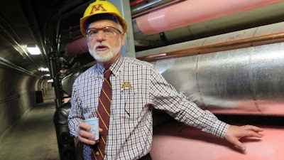In a Dec. 20, 2017 photo, Jerome Malmquist, the University of Minnesota's energy management director, points out steam pipes during a tour of the new Main Energy Plant in Minneapolis. The plant is designed to be efficient and save the university about $2 million in utility costs.