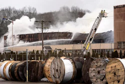 Fire officials work a fire at a Willimantic Waste Paper Co., Inc. building at 1590 West Main Street Sunday, Jan. 28, 2018, in Willimantic, Conn. Fire officials say several departments are on the scene east of Hartford.