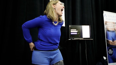 Mariana Marcaletti laughs as she tries on a Spartan boxer, an underwear that blocks radiation from wireless devices, during CES Unveiled at CES International Sunday, Jan. 7, 2018, in Las Vegas.