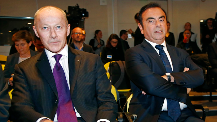 French car maker Renault CEO Carlos Ghosn, right, and his new deputy Thierry Bollore pose for photographers before the presentation of the company 2017 at the headquarters in Boulogne-Billancourt, outside Paris, Friday Feb. 16, 2018. French carmaker Renault says it had record profit and sales last year, boosting its shares and CEO Carlos Ghosn's bid to keep his job.