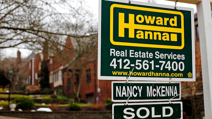 In this Monday, Jan. 22, 2018 file photo, a for sale sign is displayed in front of a home in Mount Lebanon, Pa. Economists are generally bullish in their outlooks for 2018: Most expect the new U.S. tax cuts, a sturdier global economy and a healthy job market to support consumer and business spending and a steady if modest pace of hiring. And many Americans appear confident enough to buy homes: Sales of existing houses reached their highest level in 11 years in 2017.