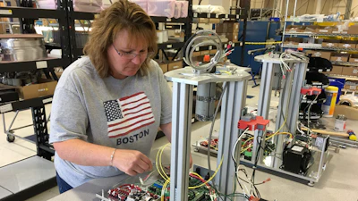 Kim Deforest, Polymer Test Cell Assembly, is assembling a Laboratory Melt Indexer base unit at Dynisco’s Franklin, MA plant.