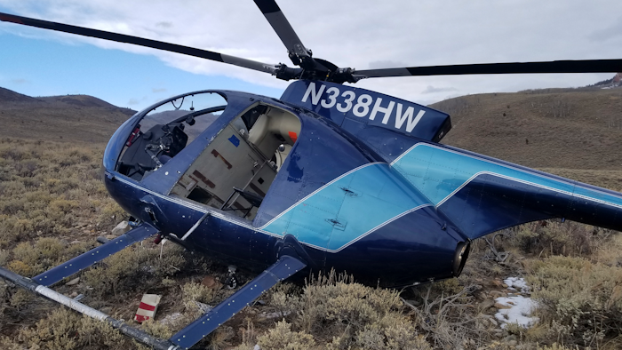 In this photo taken Monday, Feb. 12, 2018, and provided by the Wasatch County Sheriff's Office is a research helicopter that was brought down by a leaping elk in the mountains of eastern Utah. Wasatch County authorities say the elk jumped into the chopper's tail rotor as the craft flew low, trying to capture the animal with a net. The two people on board weren't seriously hurt, but wildlife officials say the elk died of its injuries. The state-contracted Australian crew had been trying to capture and sedate the elk so they could collar it and research its movements about 90 miles east of Salt Lake City.