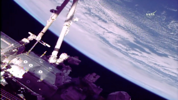 This photo provided by NASA shows astronauts Norishige Kanai of Japan, left, and NASA astronaut Mark Vande Hei during a spacewalk on the International Space Station on Friday, Feb. 16, 2018. The astronauts are wrapping up months of repair work on the station's big robot arm. The 58-foot robot arm had both of its aging mechanical hands replaced on previous spacewalks.