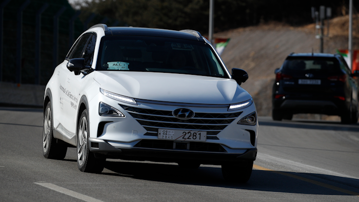 In this Monday, Feb. 12, 2018, photo, Hyundai's autonomous fuel cell electric vehicle Nexo is driven along a road near the Pyeongchang Olympic Stadium in Pyeongchang, South Korea. At Pyeongchang Winter Olympic Games, there are two futures of self-driving vehicles in two different Olympic venues by two different companies. In a reminder of a proxy war between automakers and tech companies, Hyundai and KT have negotiated over the exclusive right to use the buzzword.