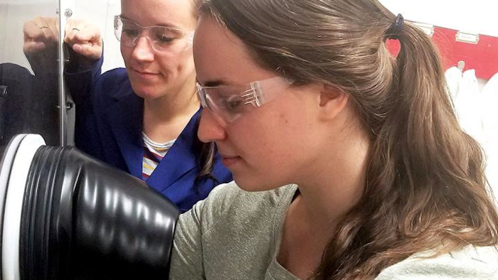 Ellen Matson, left, University of Rochester assistant professor of chemistry, and University of Rochester PhD student Lauren VanGelder at work in Matson's lab. VanGelder is lead author on a paper describing modifications to a redox flow battery that make it nearly twice as effective for electrochemical energy storage.
