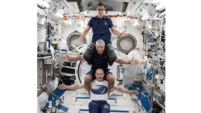 This image provided by NASA on Feb. 25, 2018, shows from bottom to top: Russia’s Alexander Misurkin, NASA’s Mark Vande Hei, middle, and NASA’s Joe Acaba posing for a photograph at the International Space Station. The three astronauts are headed back to Earth on Tuesday, Feb. 27, following a nearly six-month mission at the International Space Station. Misurkin, Vande Hei and Acaba moved into the orbiting lab in September. They are targeting a Kazakhstan touchdown for their Russian capsule.