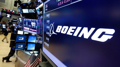 In this July 24, 2017 file photo, the Boeing logo appears above a trading post on the floor of the New York Stock Exchange. Boeing Co. on Wednesday, Jan. 31, 2018, reported fourth-quarter profit of $3.13 billion. The Chicago-based company said it had net income of $5.18 per share. Earnings, adjusted for pretax gains, came to $4.80 per share.