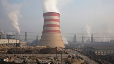 In this Dec. 30, 2016, file photo, smoke and steam spew from the sprawling complex that is a part of the Jiujiang steel and rolling mills in Qianan in northern China's Hebei province. The Commerce Department is urging President Donald Trump to impose tariffs or quotas on imported aluminum and steel. The recommendations unveiled by Secretary Wilbur Ross on Friday, Feb. 16, 2018, are likely to escalate tensions with China and other U.S. trading partners.