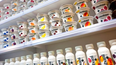 In this Nov. 20, 2017, file photo, Chobani yogurt cups are displayed in New York. As Chobani turns 10, CEO and founder Hamdi Ulukaya talked to The Associated Press about yogurt’s place in online grocery delivery, products made from almonds and peas that are moving into the yogurt case and why the company is giving away free yogurts.