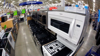 This Jan. 22, 2018, file photo shows a Whirlpool microwave and oven on display in the appliance section of a Lowe's in Wexford, Pa. On Tuesday, Feb. 27, 2017, the Commerce Department releases its report on durable goods for January.