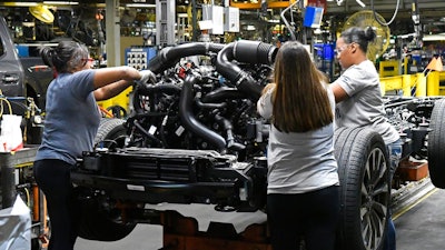 In this Friday, Oct. 27, 2017, photo, workers assemble Ford trucks at the Ford Kentucky Truck Plant, in Louisville, Ky. On Thursday, Feb. 1, 2018, the Institute for Supply Management, a trade group of purchasing managers, issues its index of manufacturing activity for January.