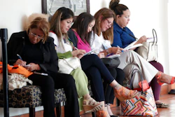 In this Tuesday, Jan. 30, 2018, photo, women fill out job applications at a JobNewsUSA job fair in Miami Lakes, Fla. The Labor Department reports on job openings and labor turnover for December, on Tuesday, Feb. 6.