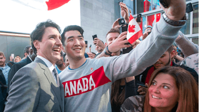 Prime Minister Justin Trudeau poses for photos with employees as he leaves the offices of Salesforce on Thursday, Feb. 8, 2018 in San Francisco.