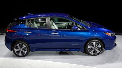 In this Tuesday, Sept. 5, 2017, file photo, the 2018 Nissan Leaf is on display during an unveiling event in Las Vegas. Electric car prices are falling, but they still cost more than equivalent gas models because of their expensive batteries.