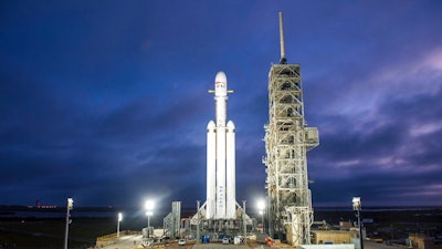 This Dec. 28, 2017 photo made available by SpaceX shows a Falcon Heavy rocket in Cape Canaveral, Fla. With more than 5 million pounds of liftoff thrust the Heavy will be capable of lifting super-size satellites into orbit and sending spacecraft to the moon, Mars and beyond.