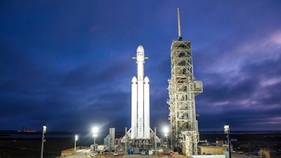 This Dec. 28, 2017 photo made available by SpaceX shows a Falcon Heavy rocket in Cape Canaveral, Fla. With more than 5 million pounds of liftoff thrust the Heavy will be capable of lifting super-size satellites into orbit and sending spacecraft to the moon, Mars and beyond.