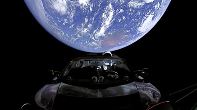 This image from video provided by SpaceX shows the company's spacesuit in Elon Musk's red Tesla sports car which was launched into space during the first test flight of the Falcon Heavy rocket on Tuesday, Feb. 6, 2018.