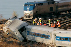 In a Dec. 1, 2013, file photo, an Amtrak train, top, traveling on an unaffected track, passes a derailed Metro North commuter train, in the Bronx borough of New York. President Donald Trump is putting the brakes on attempts to address dangerous transportation safety problems from speeding tractor-trailers to sleepy railroad engineers as part of his quest to roll back regulations across the government.