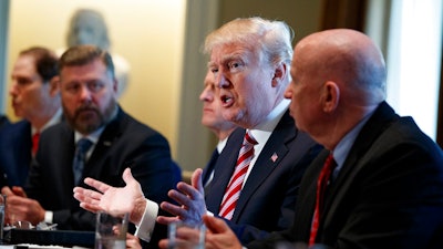 President Donald Trump speaks during a meeting with lawmakers about trade policy in the Cabinet Room of the White House, Tuesday, Feb. 13, 2018, in Washington. From left, Sen. Ron Wyden, R-Ore., Rep. Rick Crawford, R-Ariz., Sen. Pat Toomey, R-Pa., Trump, and Rep. Kevin Brady, R-Texas.
