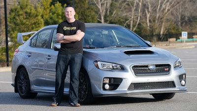 In this Friday, Feb. 9, 2018, photo, Jonathan Cypert stands in front of his wife's 2017 Subaru Impreza, in Virginia, that he purchased with bitcoins he acquired in 2011. Cypert sees his bitcoin cache as a nest egg to tide him over after he retires from the military.
