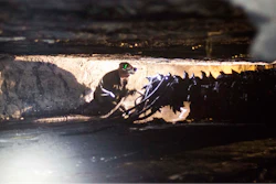 Coal miner Scott Tiller works next to a drill in an underground coal mine roughly 40 inches high in Welch, West Virginia.