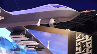 A model of a Wing Loong II weaponized drone hangs above the stand for the China National Aero-Technology Import & Export Corp. at a military drone conference in Abu Dhabi, United Arab Emirates, Sunday, Feb. 25, 2018. The United Arab Emirates on Sunday opened a stand-alone trade show featuring military drones called the Unmanned Systems Exhibition & Conference, showing the power the weapons have across the Middle East.